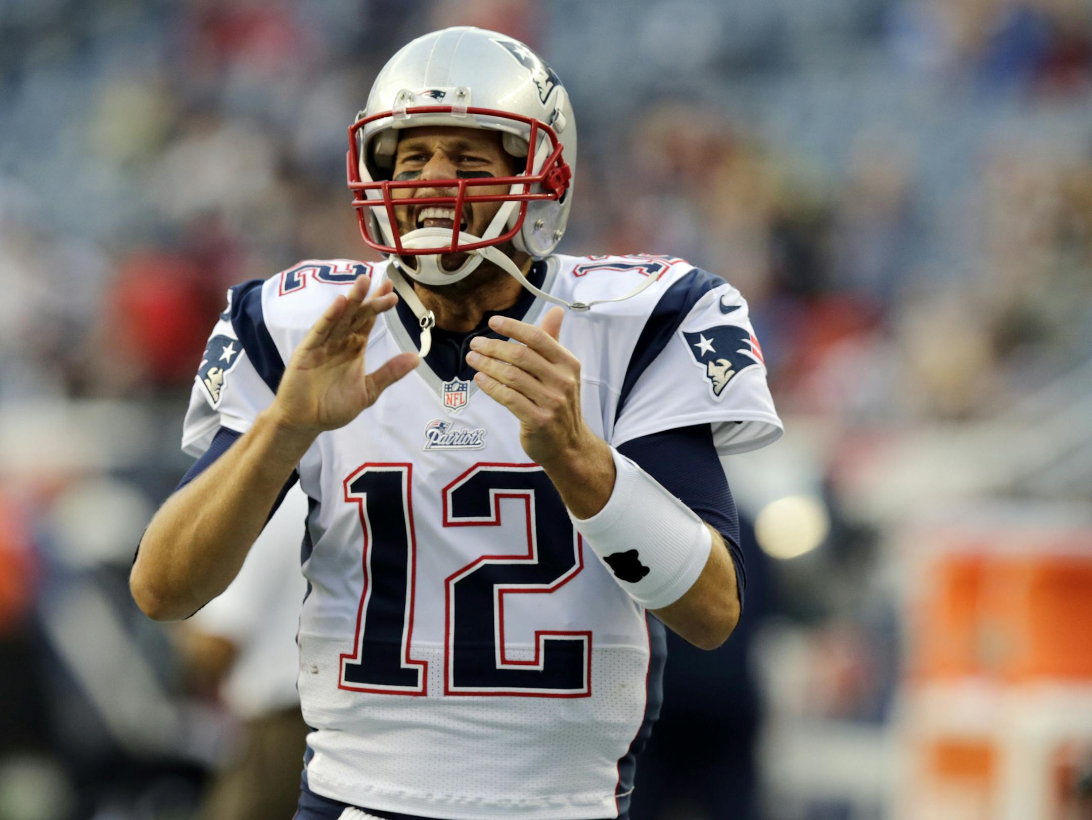 New England Patriots quarterback Tom Brady runs onto the field before an NFL preseason football game against the Carolina Panthers Friday, Aug. 22, 2014, in Foxborough, Mass. (AP Photo/Charles Krupa) ORG XMIT: FBO101