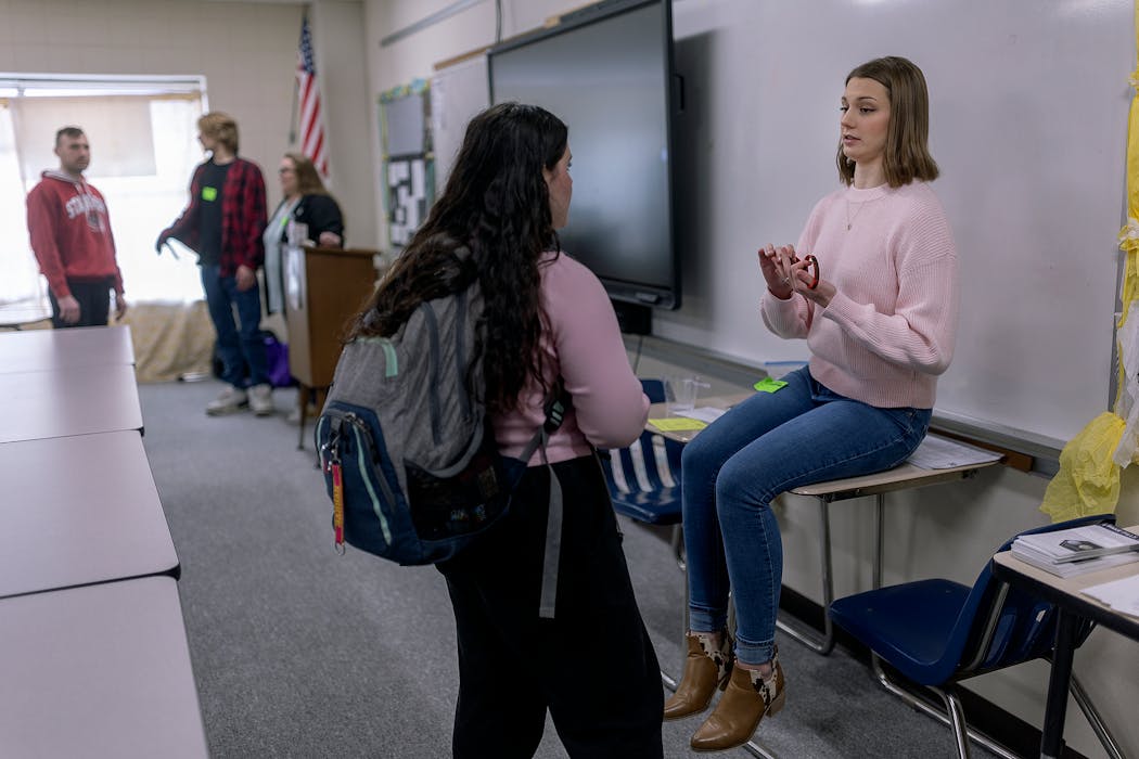 Devin Norring's sister, Hayley Norring, talks to students after her family's presentation at Hastings High School on April 3.