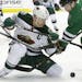 Minnesota Wild center Mikko Koivu (9) and Dallas Stars left wing Antoine Roussel (21) battle for the puck during the first period in Game 2 in the fir
