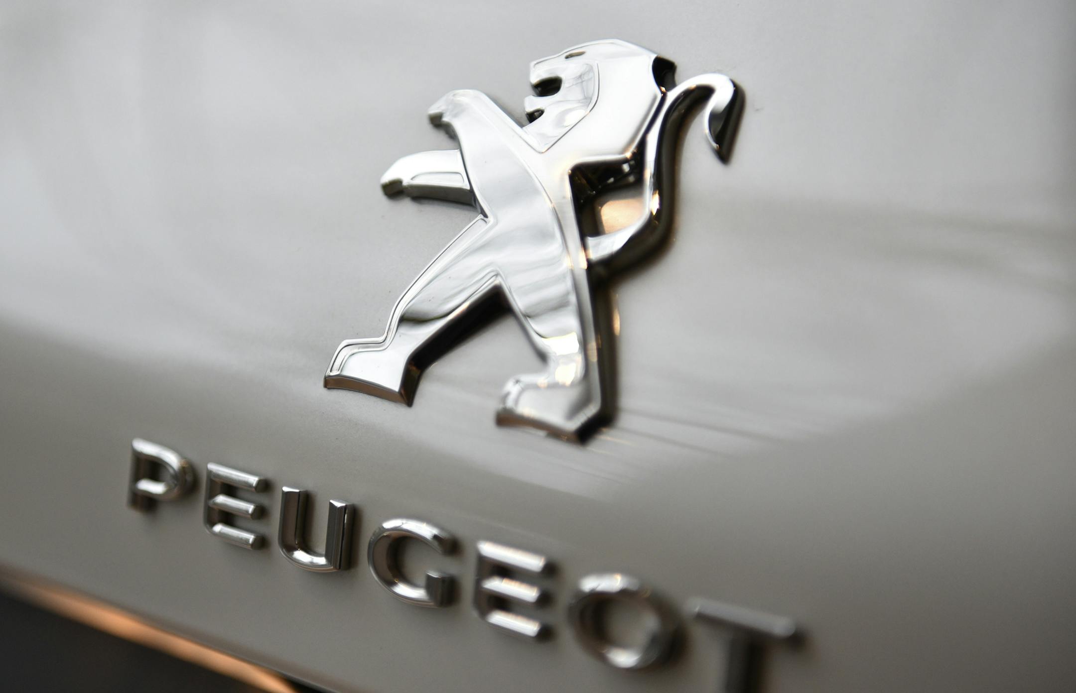The logos of French car maker Peugeot is displayed on a car during a press conference held in Paris, France, Monday, March 6, 2017. General Motors is selling its loss-making European car business, including Germany's Opel and British brand Vauxhall, to France's PSA group in a deal that realigns the industry in the region. (AP Photo/Zacharie Scheurer)