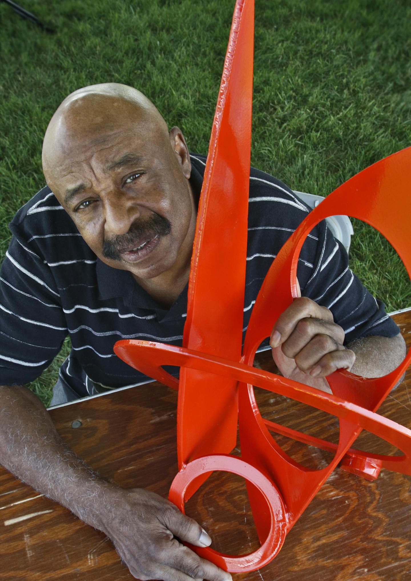 Artist Melvin Smith with a replica of "Metamorphosis", an abstract sculpture he has been commissioned to design for the grounds of the Art House in Eagan. (MARLIN LEVISON/STARTRIBUNE(mlevison@startribune.com