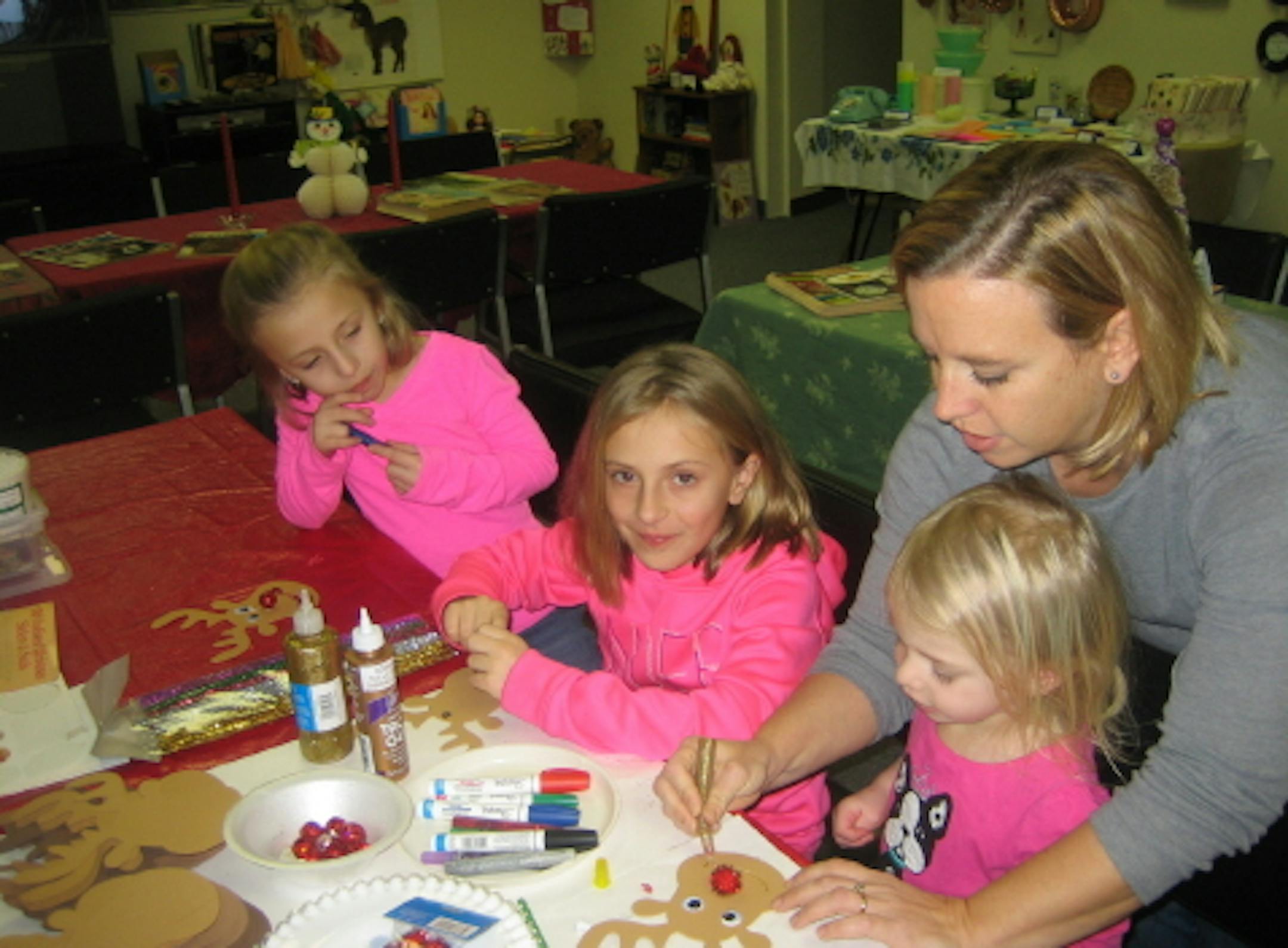 credit: Mary Ann Hoffman, Fridley Historical Society Angie Kokesh of Ramsey and daughters (l-r) Anna, Megan and Molly worked on their Rudolph the Red-Nosed Reindeer creations at the Fridley Historical Society. The Society's annual holiday exhibit has a theme of Christmas in the 60s this year, and Rudolph made his television debut in December 1964. (The famous song by Gene Autrey came out in 1949 and was based on a story written 10 years earlier.)