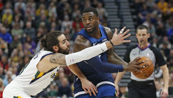 Utah Jazz guard Ricky Rubio, left, defends against Minnesota Timberwolves guard Jared Terrell during the first half of an NBA basketball game Friday, 