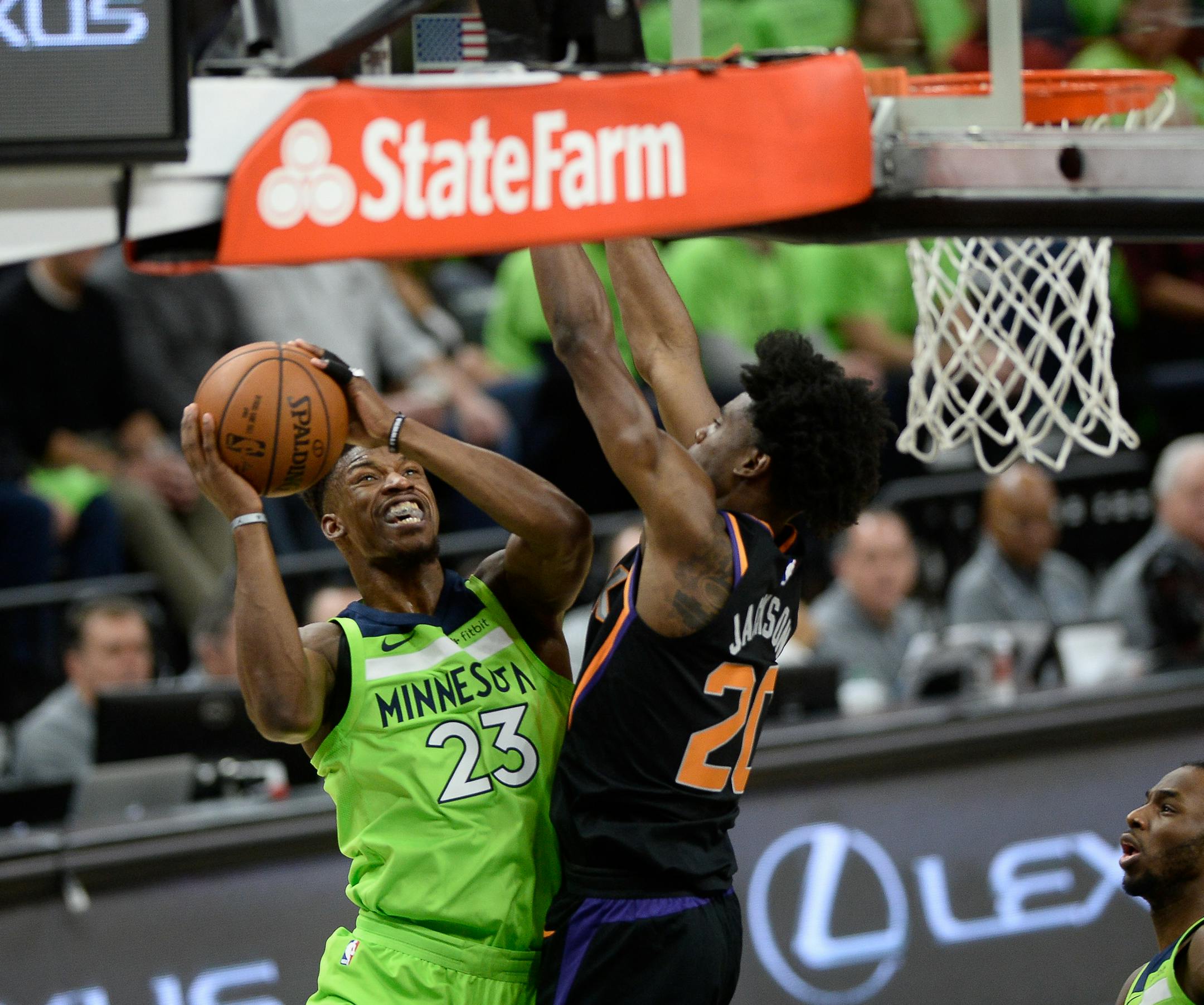 Minnesota Timberwolves guard Jimmy Butler (23) powered past the defense of Phoenix Suns forward Josh Jackson (20) for a layup in the first quarter. ] AARON LAVINSKY &#xef; aaron.lavinsky@startribune.com The Minnesota Timberwolves played the Phoenix Suns on Saturday, Dec. 16, 2017 at Target Center in Minneapolis, Minn.