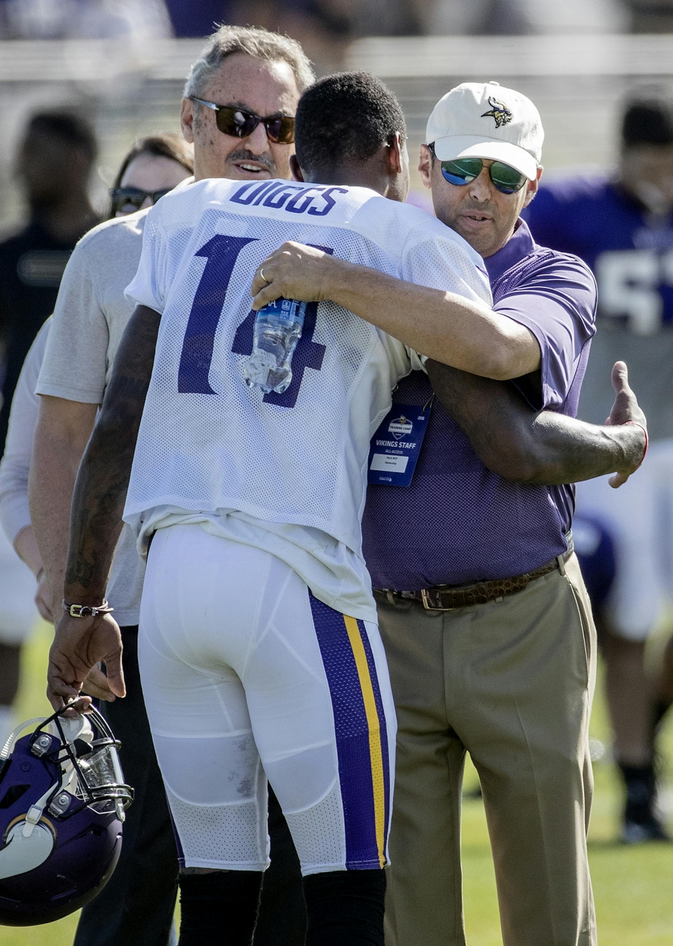 Minnesota Vikings receiver Stefon Diggs (14) was greeted by team owners Zygi Wilf and Mark Wilf after practice on Tuesday. Diggs signed a 5-year extension with the team.