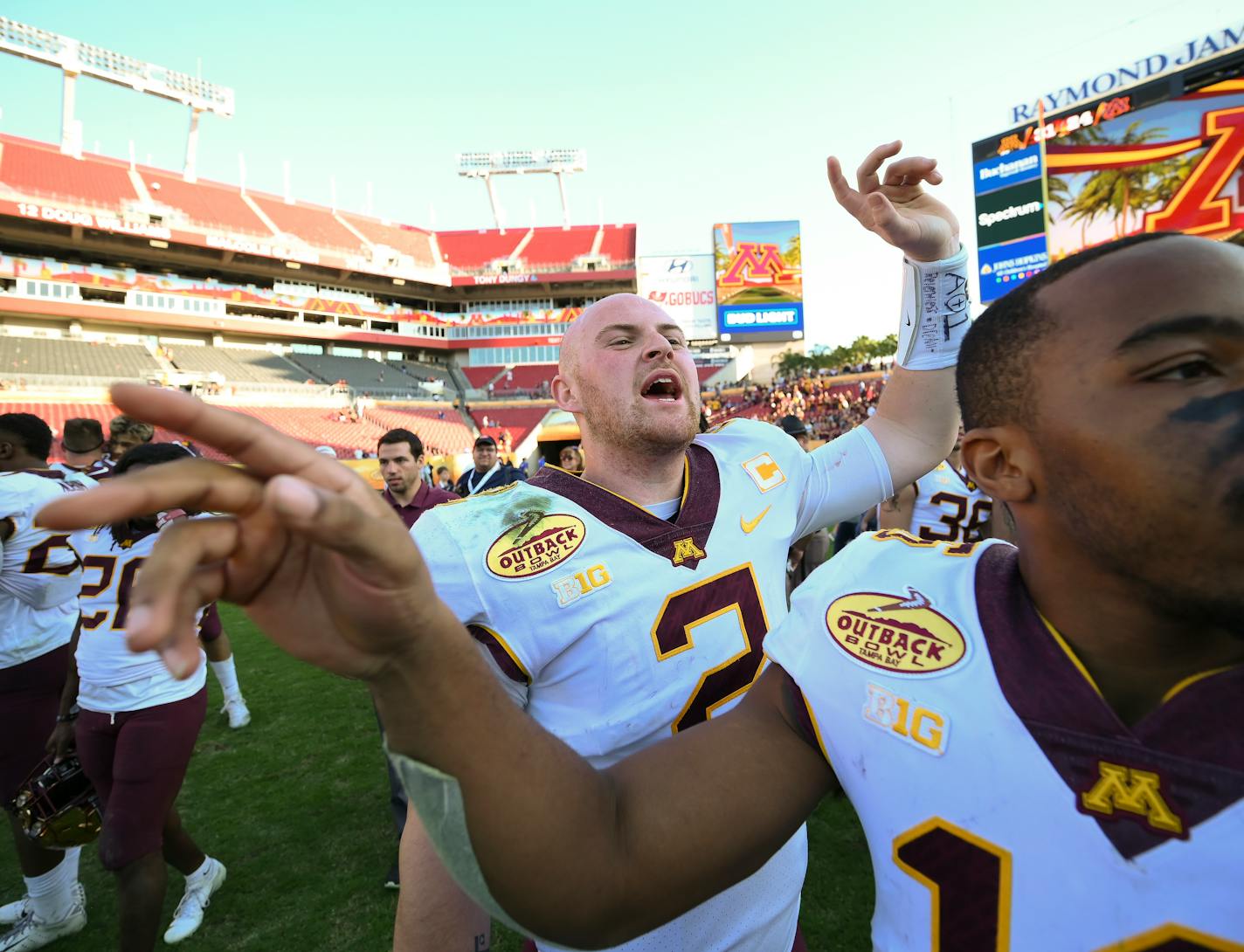 Gophers quarterback Tanner Morgan (2) and defensive back Coney Durr (16) wrangled teammates for a team photo after Minnesota's 31-24 victory over Auburn in the Outback Bowl on Wednesday.