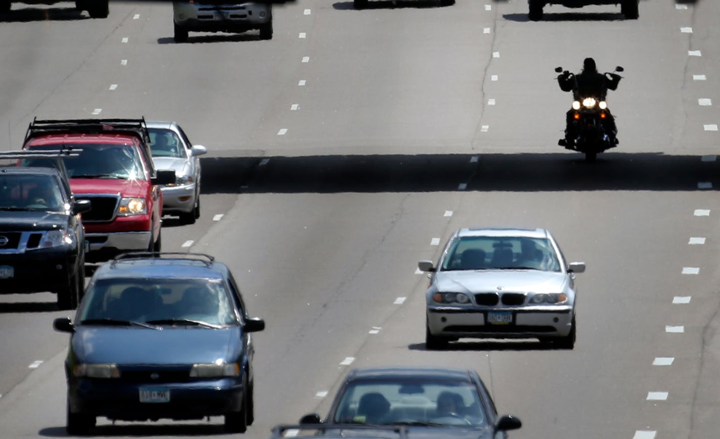 In this 2014 file photo, a motorcylcist is silhouetted beneath the 42nd Street bridge while traveling north along I-35W in Minneapolis.