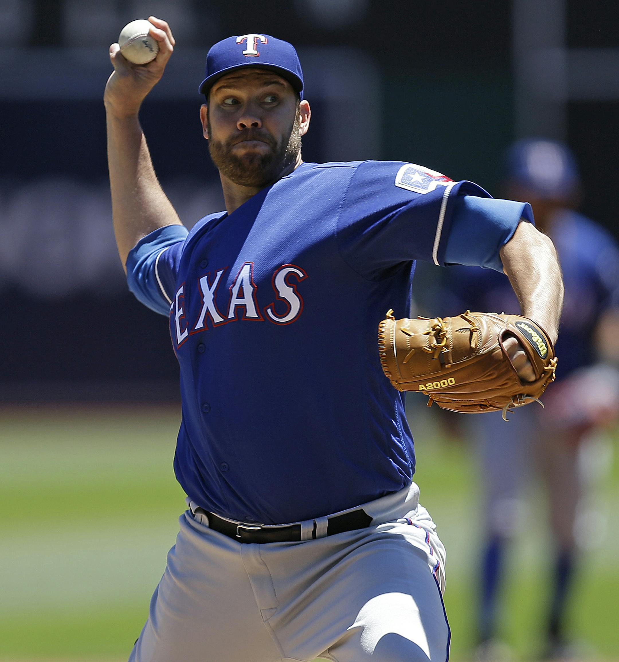 Texas Rangers pitcher Colby Lewis works against the Oakland Athletics in the first inning of a baseball game Thursday, June 16, 2016, in Oakland, Calif. (AP Photo/Ben Margot)