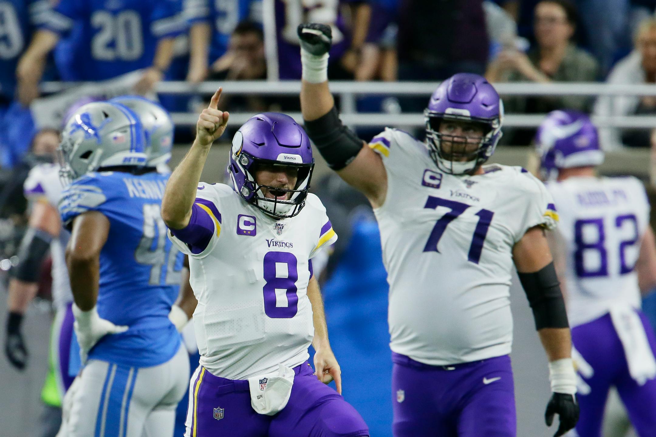 Minnesota Vikings quarterback Kirk Cousins (8) reacts after a touchdown by running back Dalvin Cook during the second half of an NFL football game against the Detroit Lions, Sunday, Oct. 20, 2019, in Detroit. (AP Photo/Duane Burleson)