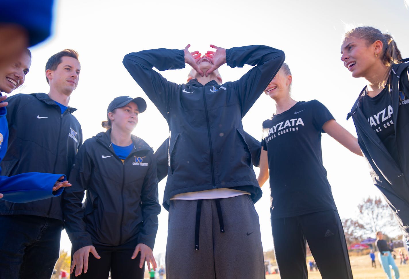 Abbey Nechanicky leads the Wayzata girl's cross country team in a chant before the MSHSL Section 6AAA Girl's Cross Country Championships Wednesday, Oct. 26, 2022 at Gale Woods Farm in Minnetrista, Minn. ]