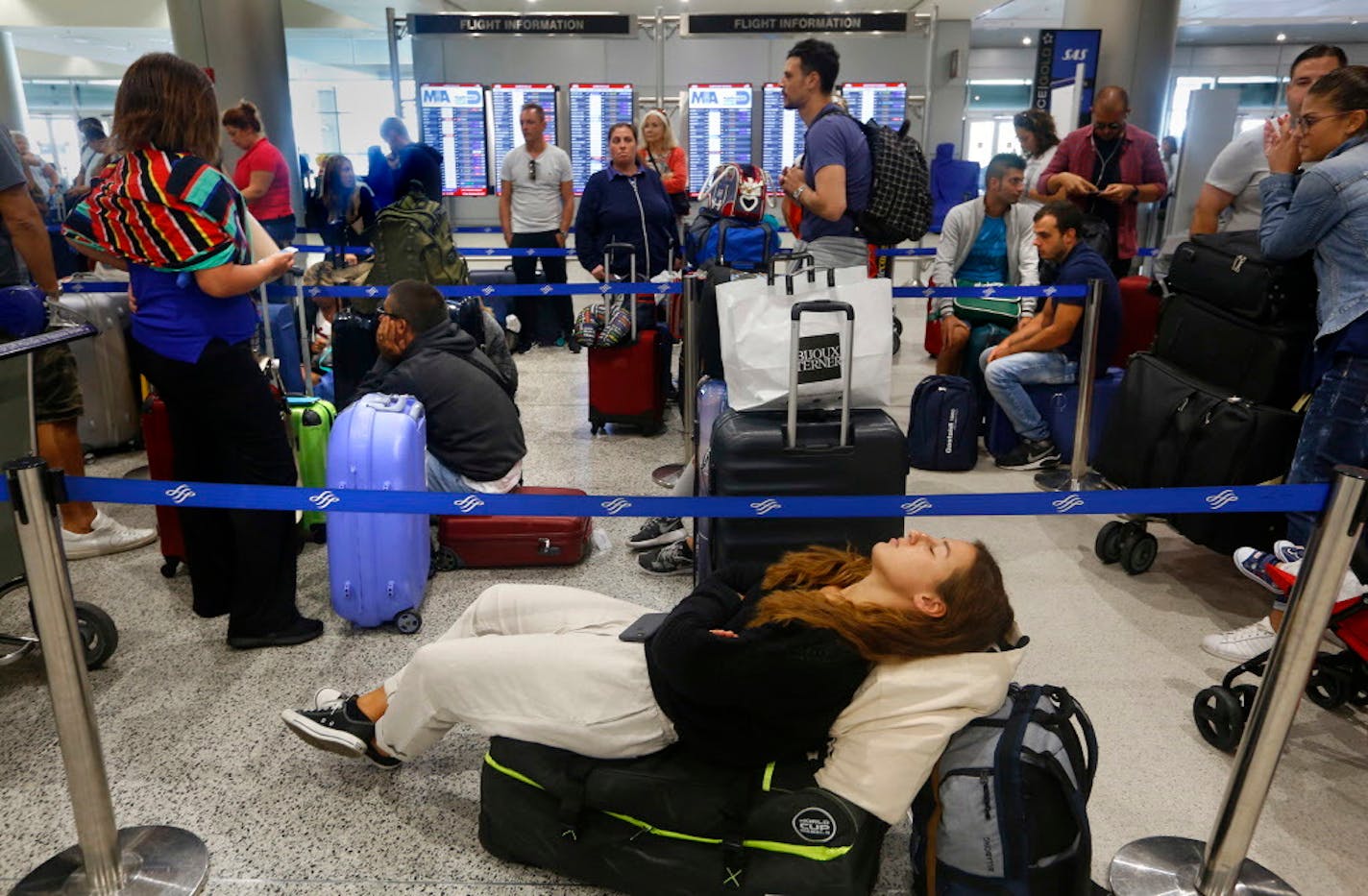 Francesca DeLuca, age 20, will be waiting for 10 hours for her flight back to Milan, Italy. She had been visiting a friend in Miami by herself, but the area where she was staying is under mandatory evacuation. At Miami International Airport, the last flights will be this afternoon with the airport closing tonight at 6pm. Most travelers are taking flights to anywhere they can find. (Carolyn Cole/Los Angeles Times/TNS) ORG XMIT: 1210636