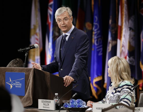 Hubert Joly, left, president and CEO of Best Buy, addresses the closing session of the National Governors Association convention Sunday, July 13, 2014