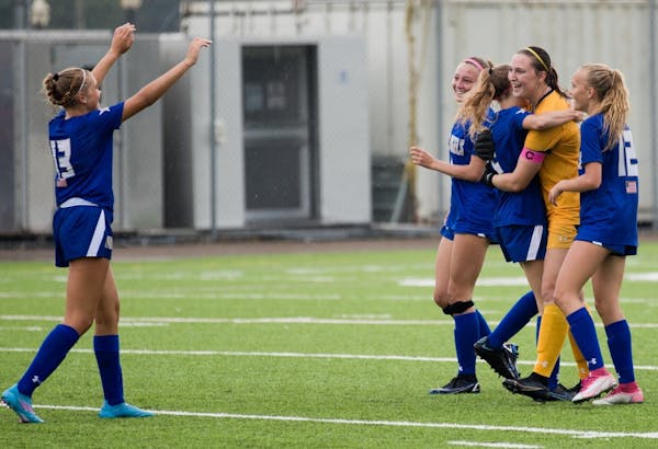 Celebration ensued when teammates surrounded goalie Chloe Sandness after she scored on a free kick against Breck.