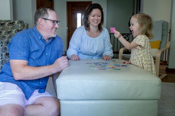 Miraya and Andy Gran played a game with daughter Isla, 2, at home in Bloomington.