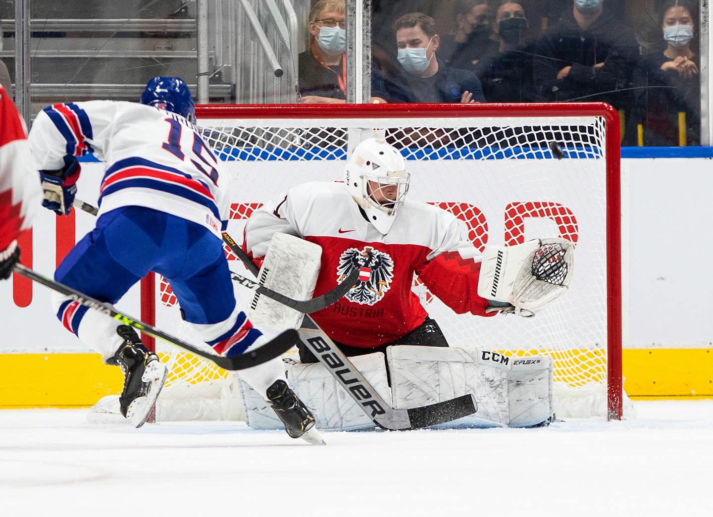 USA's Matthew Coronato (15) hits the post as Austria's goalie Leon Sommer (1) tries to make a save during the first period of an IIHF World Junior Hockey Championship game in Edmonton, Alberta, Saturday, Aug. 13, 2022. (Jason Franson/The Canadian Press via AP)