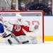 USA's Matthew Coronato (15) hits the post as Austria's goalie Leon Sommer (1) tries to make a save during the first period of an IIHF World Junior Hoc