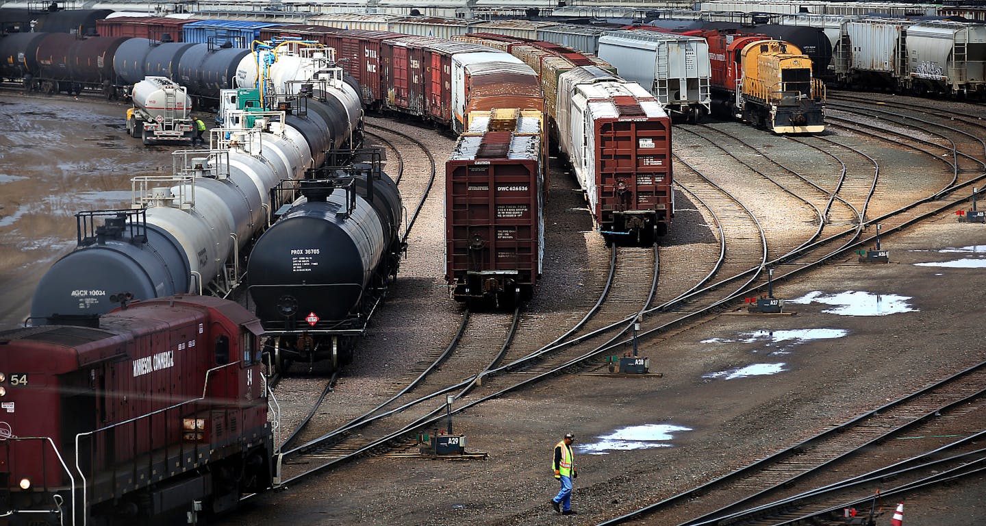 A railroad workman walked toward a switch along tracks at the Minnesota Transfer Railroad Yard in St. Paul. The worker threw a switch, which allowed a series of rail cars to change from one set of tracks to another.