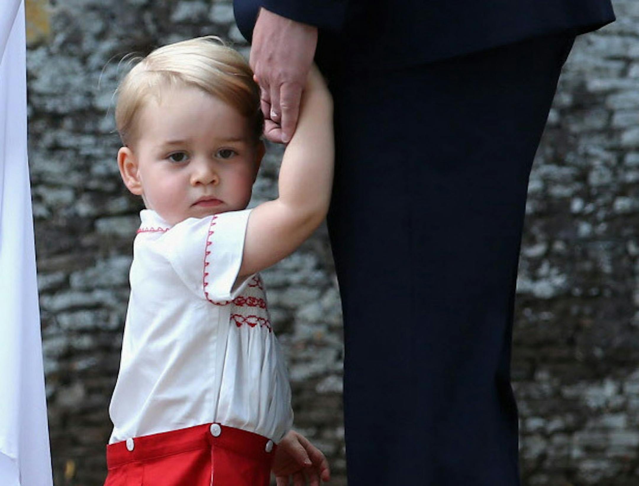 In this photo from July 5, 2015, Britain's Prince George arrives at the Church of St. Mary Magdalene on the Sandringham Estate, England, during an official media event, for the Christening of Princess Charlotte of Cambridge.