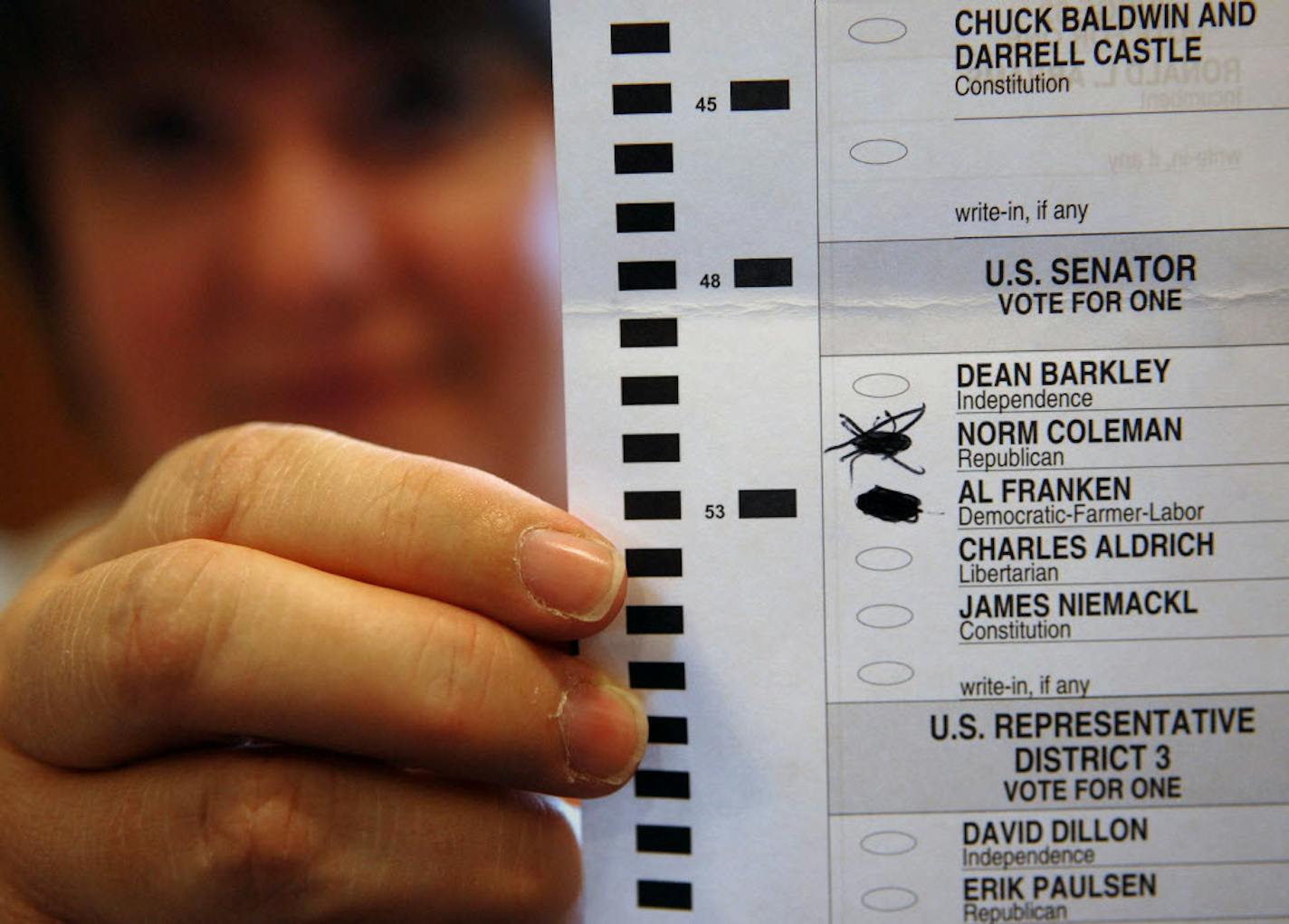 Barb Cox, a Plymouth city worker, held a ballot that drew a challenge Thursday from the Franken campaign during the U.S. Senate recount. At right are two of the more than 700 others that have been challenged by the rival campaigns and will go to the state Canvassing Board for a final decision next month.