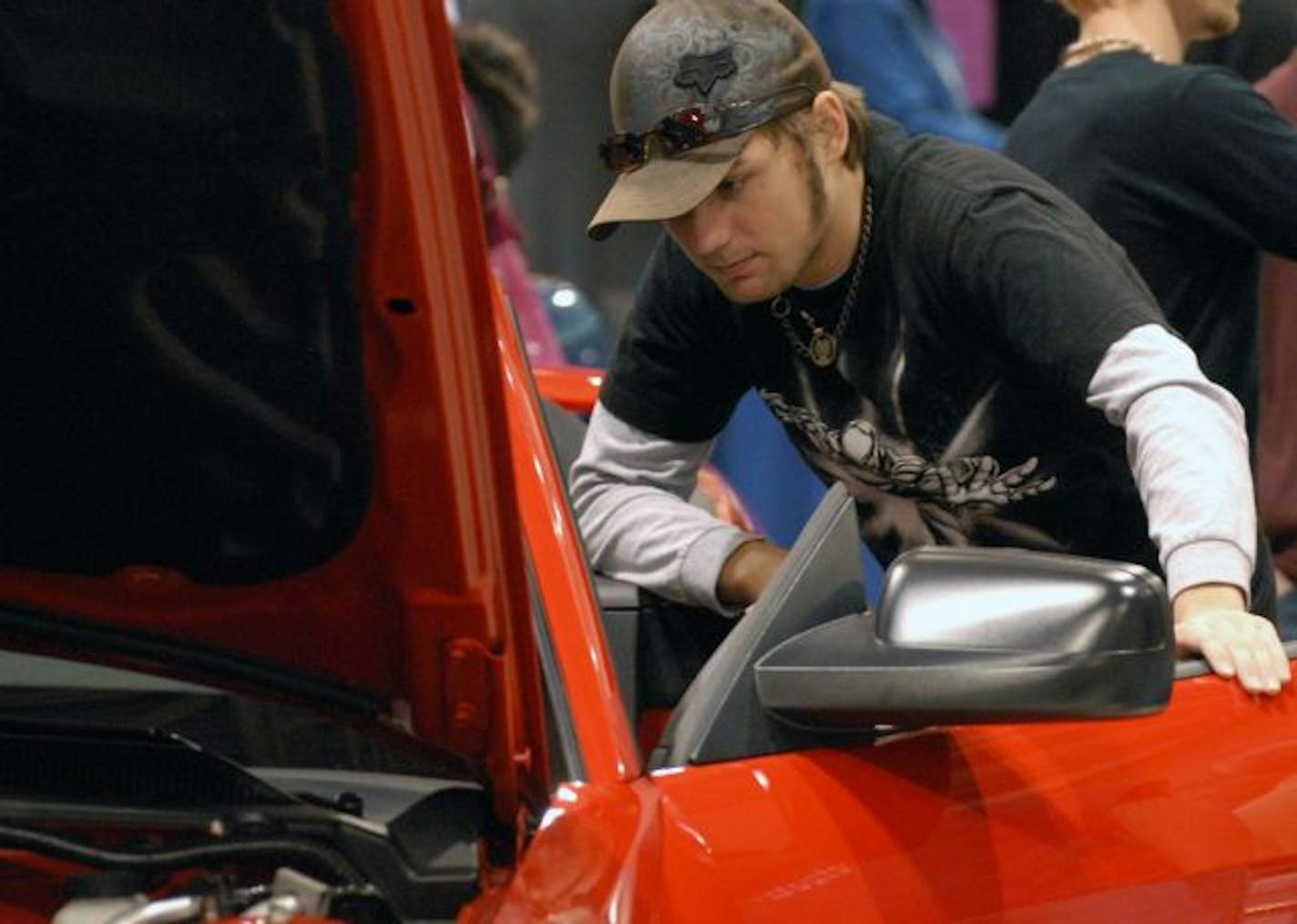 Josiah Snell of Milltown, WI. looks over a new Ford Mustang on the floor of the Minneapolis Convention Center
The auto show slogan is: Your License to Dream. Will it be just that in what has already been a dismal season for car dealers? With dealers pinning their hopes on the Auto Show, which begins March 21, we look at whether people will be just window-shopping, looking for bargains or doing some meaningful shopping? And what about the $3.75 billion in tax rebates and credits for new cars and