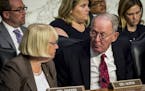 Sens. Lamar Alexander (R-Tenn.) and Patty Murray (D-Wash.) confer as state insurance commissioners appear before the Senate health committee about way