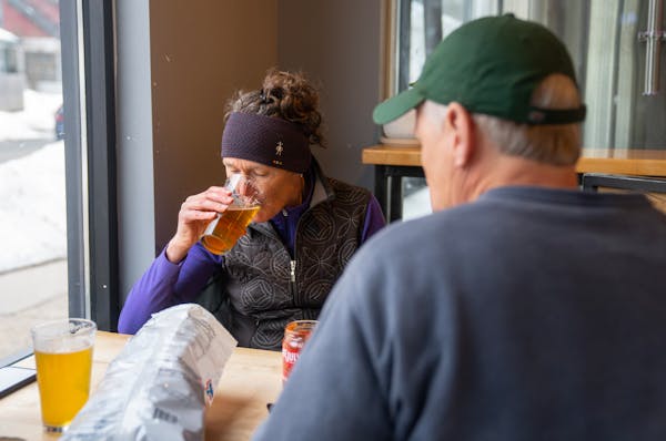 Karen Noll and Steve Welckle, members of the “Official Crew,” drank beer Wednesday at Wooden Ship Brewing Co. in Minneapolis. Patrons can join the