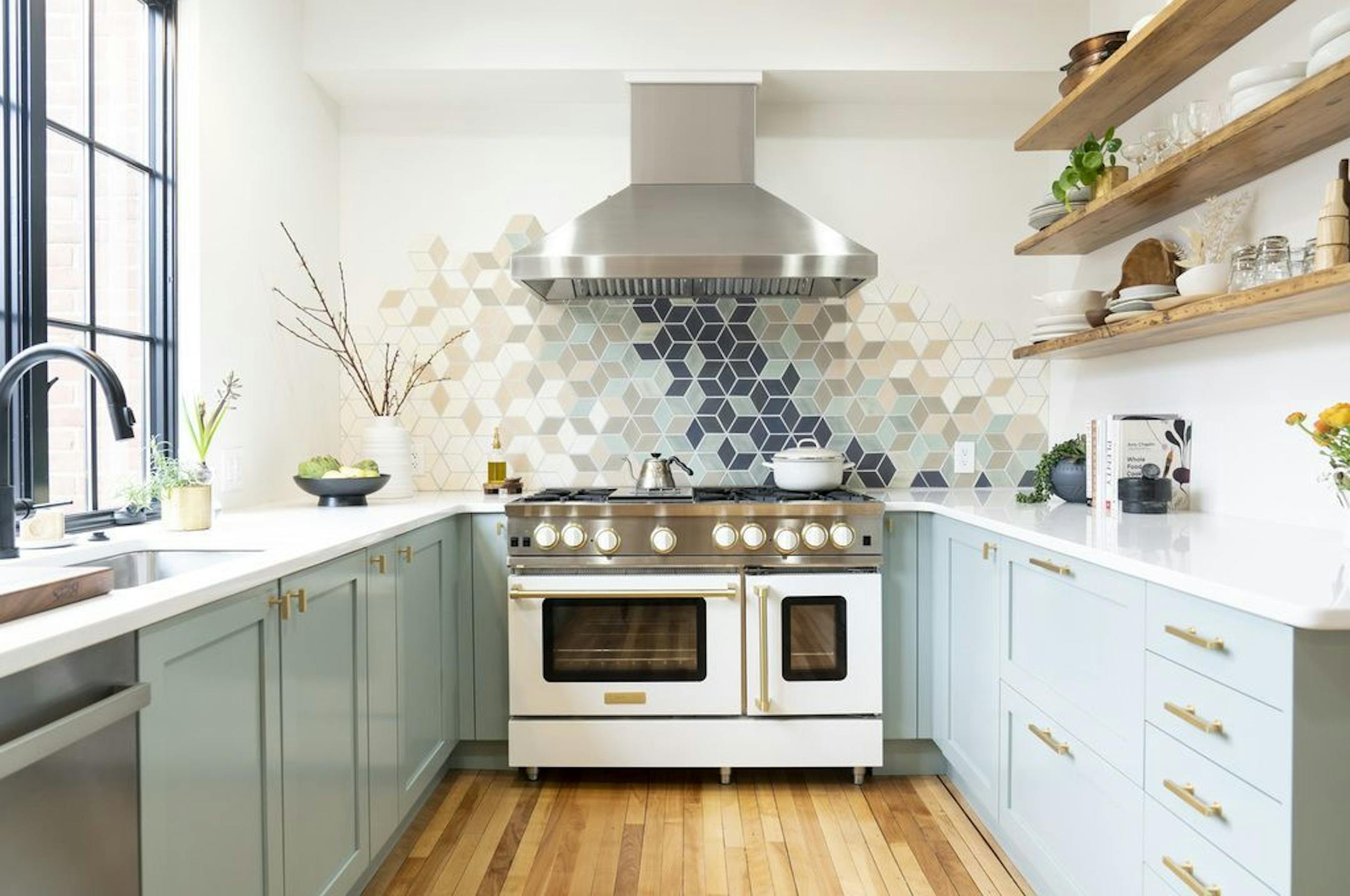 The new kitchen has a mosaic tile backsplash.