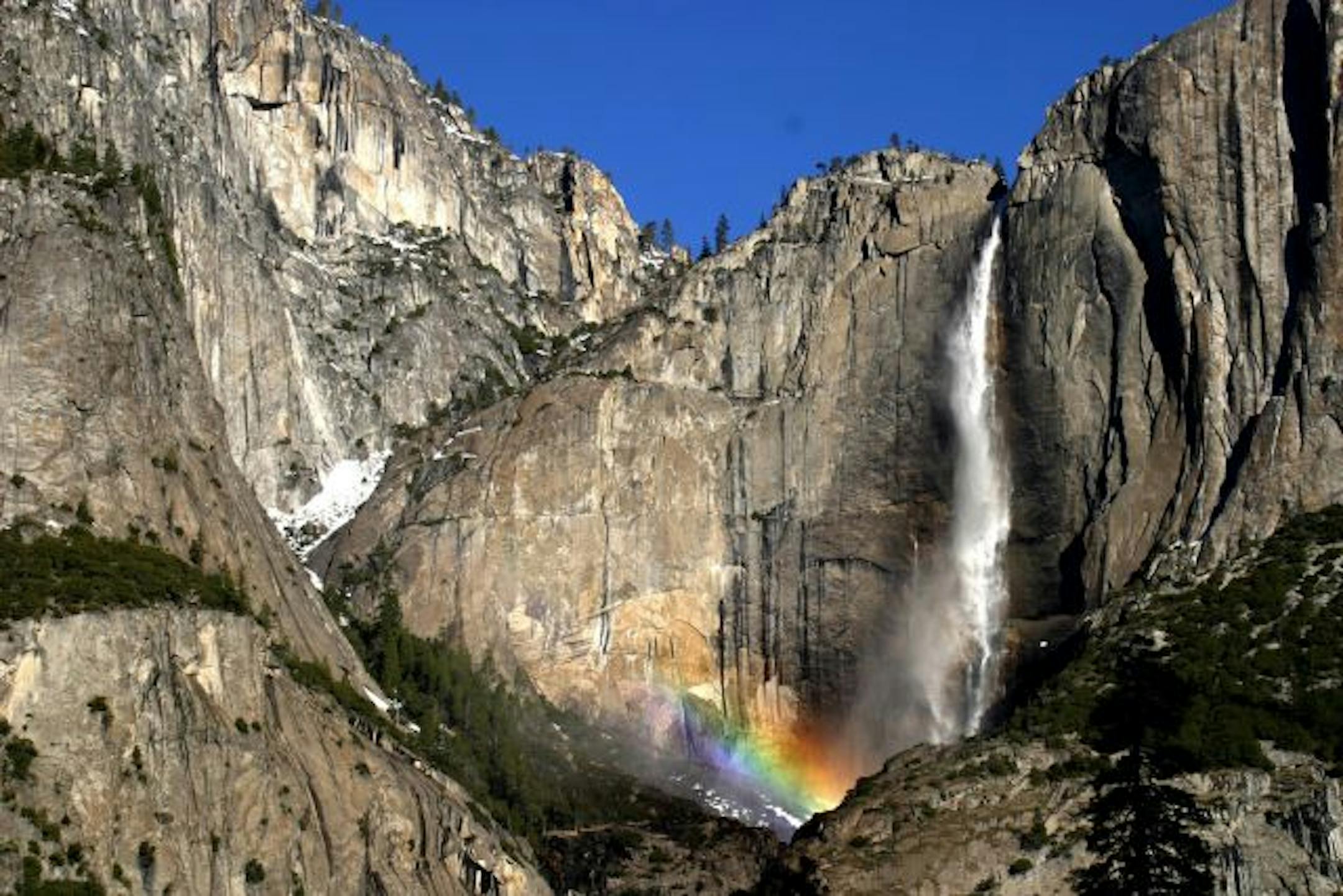 Robyn Dochterman/Star Tribune A rainbow arcs across the rugged base of Yosemite Falls, one of several notable cascades in the park.