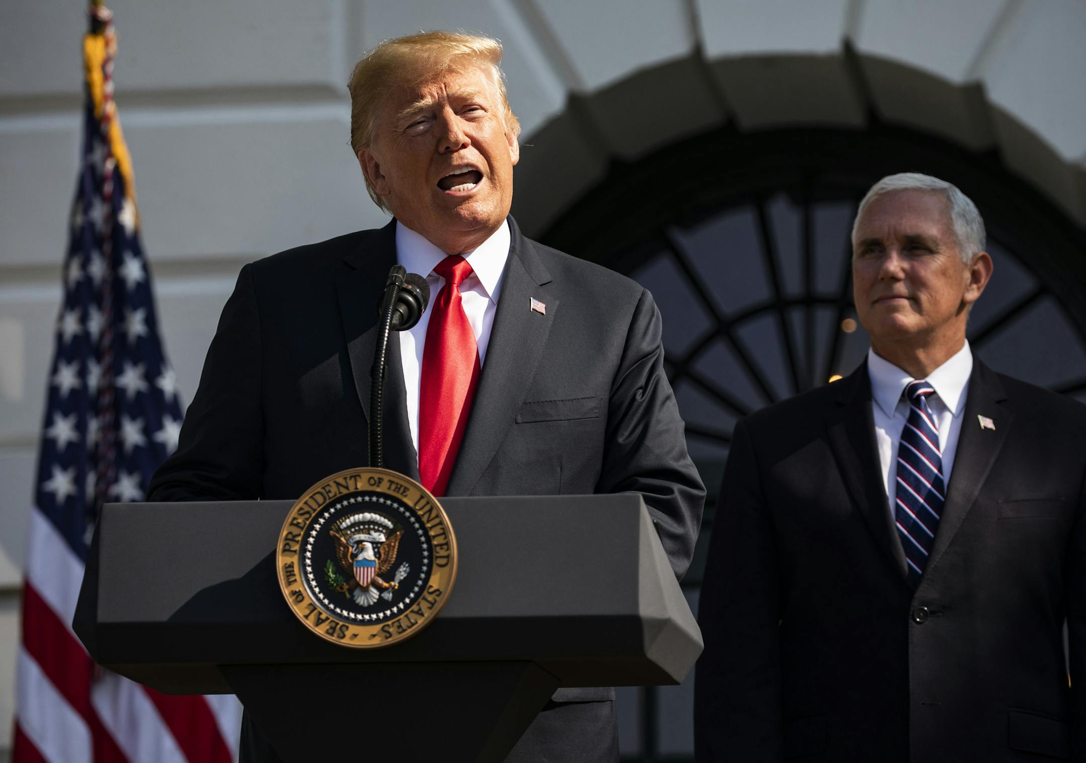 President Donald Trump speaks about the economic growth report, as Vice President Mike Pence looks on, at the White House in Washington, July 27, 2018. The Commerce Department released its initial estimate of second-quarter economic growth Friday, showing U.S. gross domestic product growth had risen at an annual rate of 4.1 percent. It was the strongest quarter of growth since 2014. (Samuel Corum/The New York Times) ORG XMIT: XNYT7