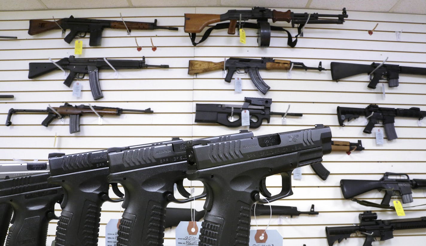 FILE--In this Jan. 16, 2013, file photo, assault weapons and hand guns are seen for sale at Capitol City Arms Supply in Springfield, Ill. Recent mass shootings spurred Congress to try to improve the background check system used during gun purchases, but experts say the system is so fractured that federal legislation being considered in Washington D.C. will do little to help keep weapons out of the hands of dangerous people. (AP Photo/Seth Perlman, file)