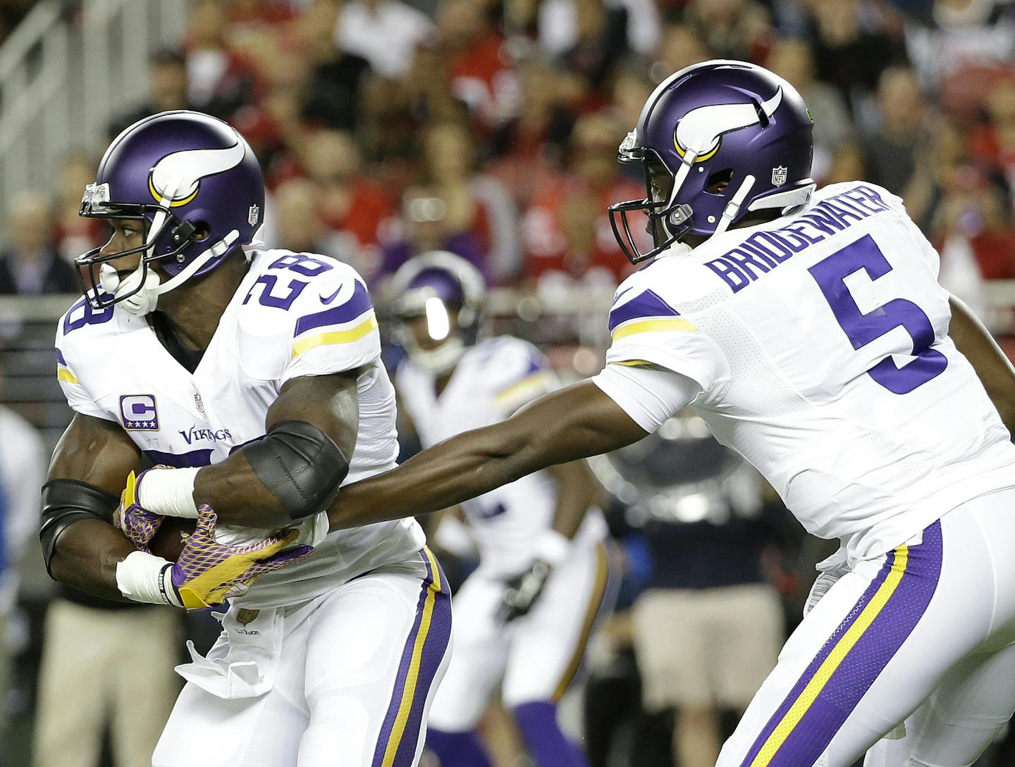 Minnesota Vikings running back Adrian Peterson (28) takes a hand off from quarterback Teddy Bridgewater (5) during the first half of an NFL football game against the San Francisco 49ers in Santa Clara, Calif., Monday, Sept. 14, 2015. (AP Photo/Marcio Jose Sanchez) ORG XMIT: MIN2015091819173198