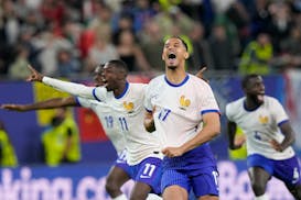 William Saliba of France celebrates after winning a quarterfinal match over Portugal at the Euro 2024 tournament in Hamburg, Germany.