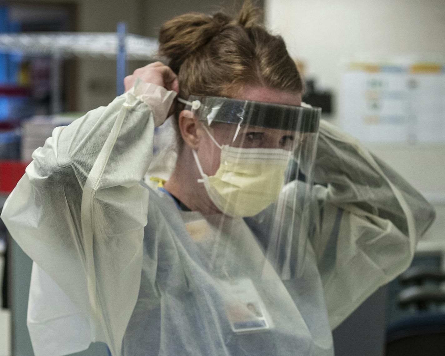 Nurse Lindsay Stewart showed the proper way to suit up in the intensive care unit of Bethesda. M Health Fairview is unveiling its retrofit of the St. Paul hospital as a COVID-19 treatment center.