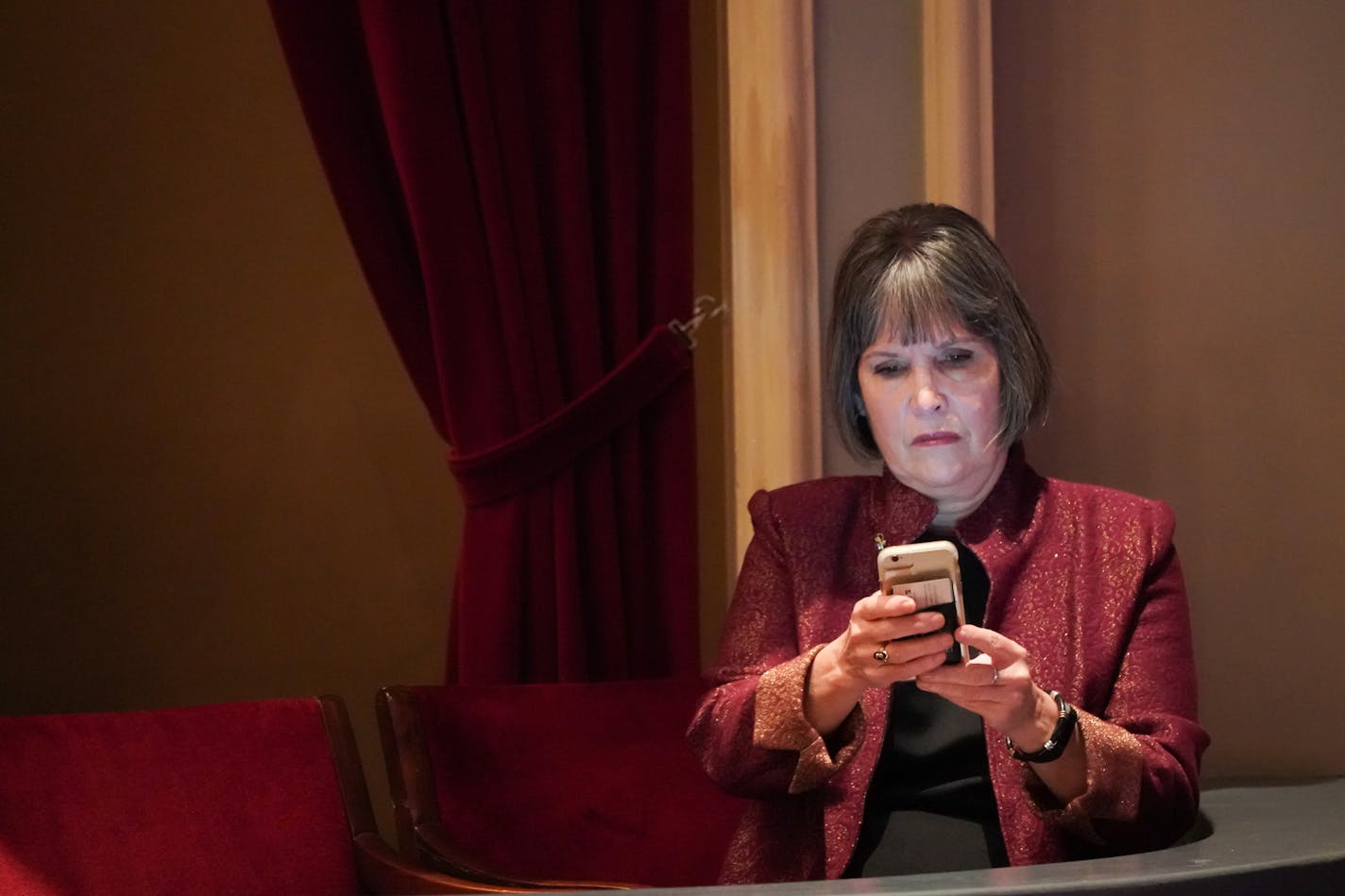 Rep. Betty McCollum checked her phone at the Fitzgerald Theater before the start of swearing in ceremonies for Governor Tim Walz and other constitutional officers.