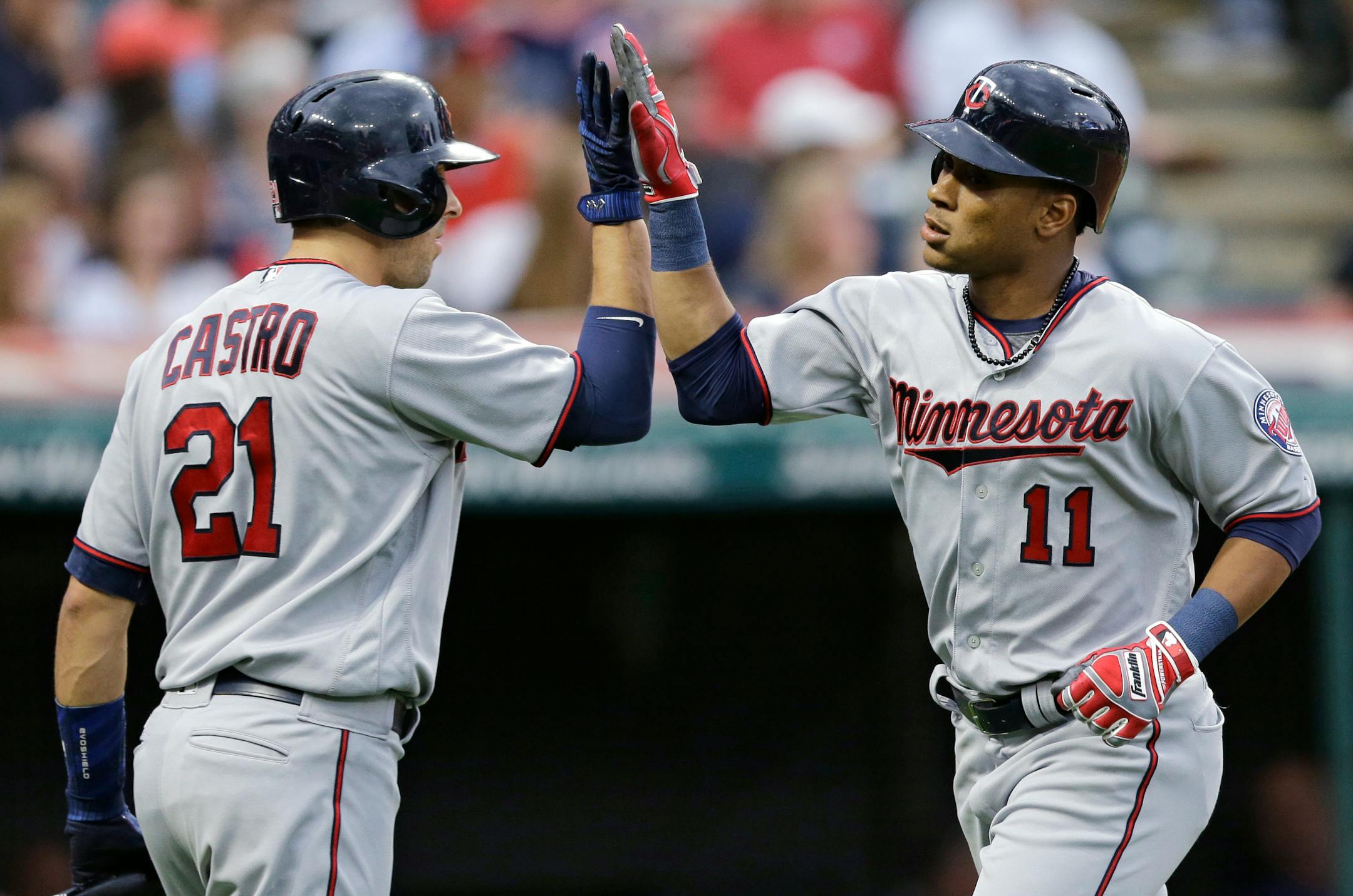 Minnesota Twins' Jorge Polanco, right, is congratulated by Jason Castro after Polanco hit a two-run home run off Cleveland Indians starting pitcher Trevor Bauer during the second inning of a baseball game, Friday, June 23, 2017, in Cleveland. (AP Photo/Tony Dejak)