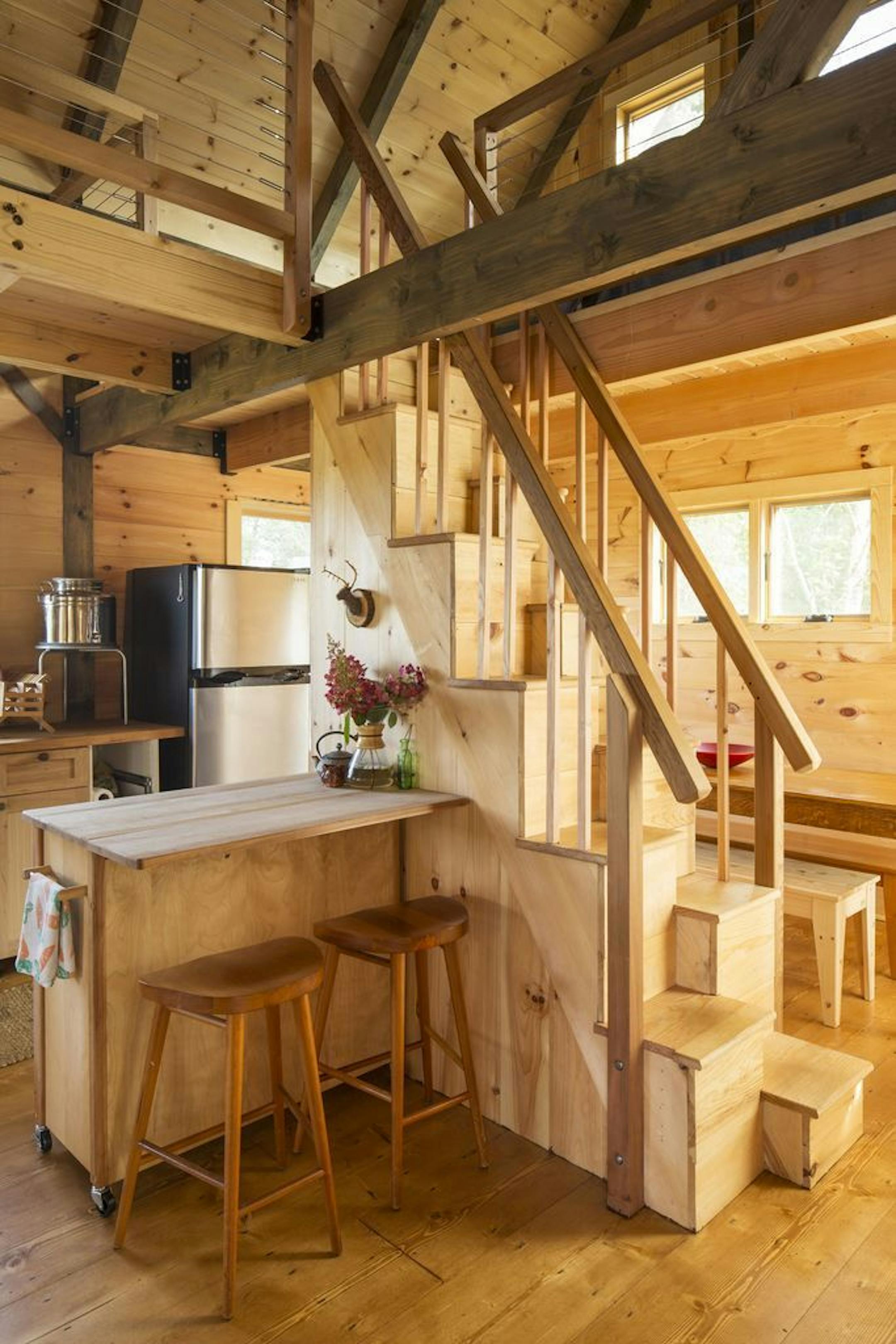 The alternating tread staircase and a rolling kitchen island save space.
