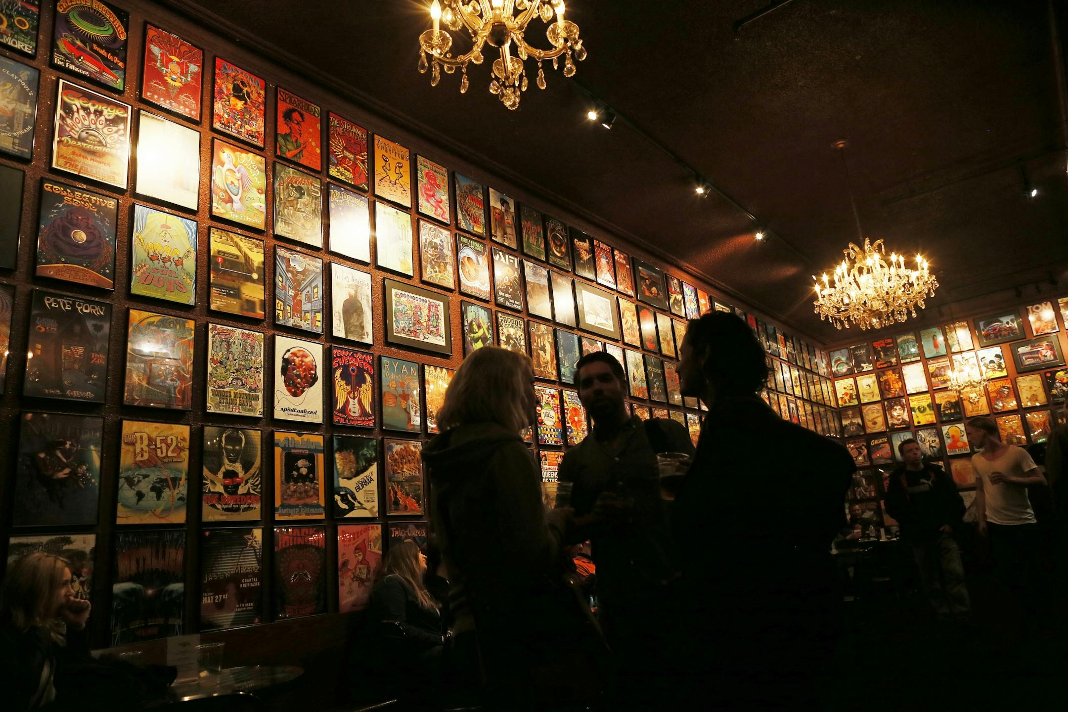 A couple looked over the posters on the walls at the Fillmore Auditorium, 1805 Geary Blvd.Photos of historic rock sites in San Francisco , CA.
