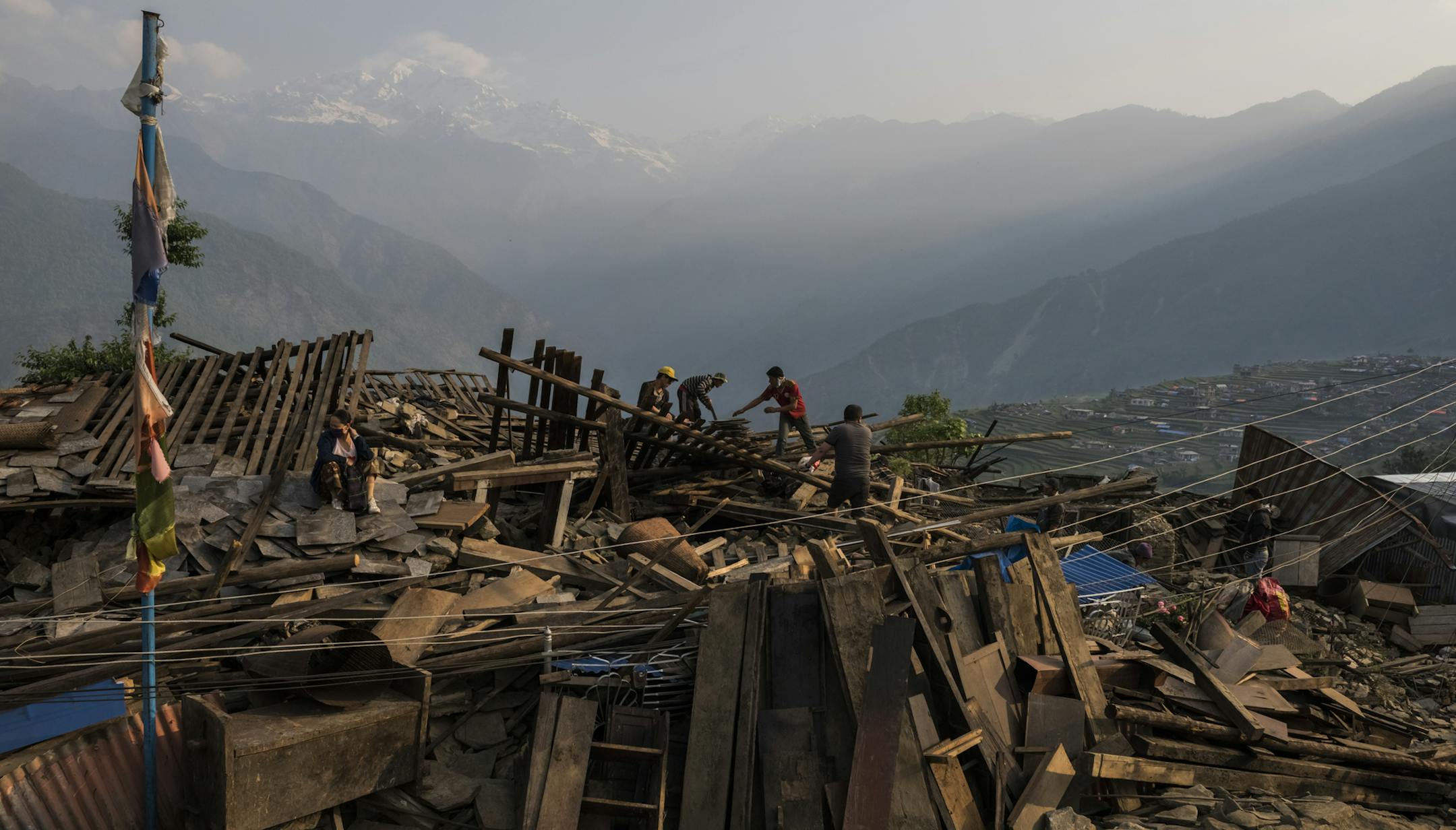 Villagers search rubble for usable items in Barpak, a village at the epicenter of the earthquake where more than 1,200 houses were destroyed or damaged, in Nepal, May 7, 2015. Barpakís once-rich agricultural life has been erased, and residents say the emergency food aid arriving by helicopter has barely been enough to get by. (Daniel Berehulak/The New York Times) ORG XMIT: XNYT46