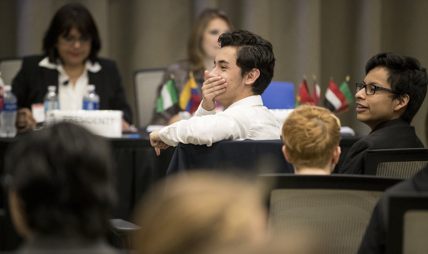 While representing Saudi Arabia, Nic Figueroa (in white) and Pedro Ochoa, both of Benilde St. Margaret, laughed at a friend during a light moment at the Spanish-language model UN, the only one of its kind in the nation, at Cargill in Wayzata, Minn., on Tuesday, April 18, 2017. Both boys speak Spanish at home. ] RENEE JONES SCHNEIDER &#x2022; renee.jones@startribune.com