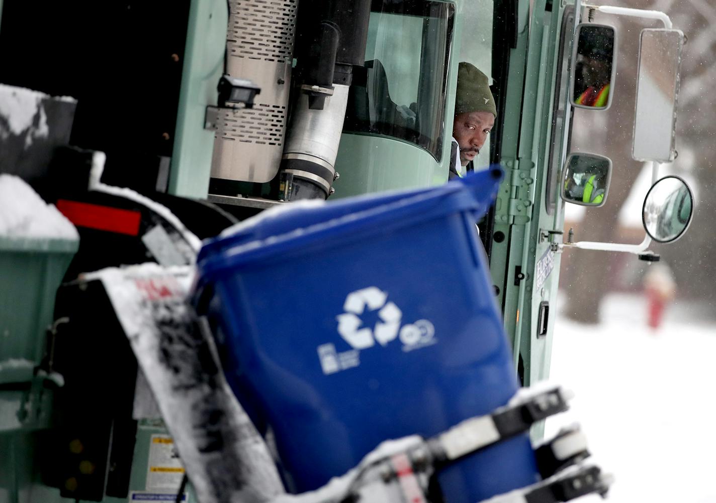 Driver Mourssalou Boukari made a recycling round early Wednesday, January 25, 2017 in St. Paul, MN. The first couple of weeks with new recycling trucks, 80,000 new recycling bins and new recycling pickup days has been frustrating for thousands of St. Paul residents. ] (ELIZABETH FLORES/STAR TRIBUNE) ELIZABETH FLORES &#x2022; eflores@startribune.com