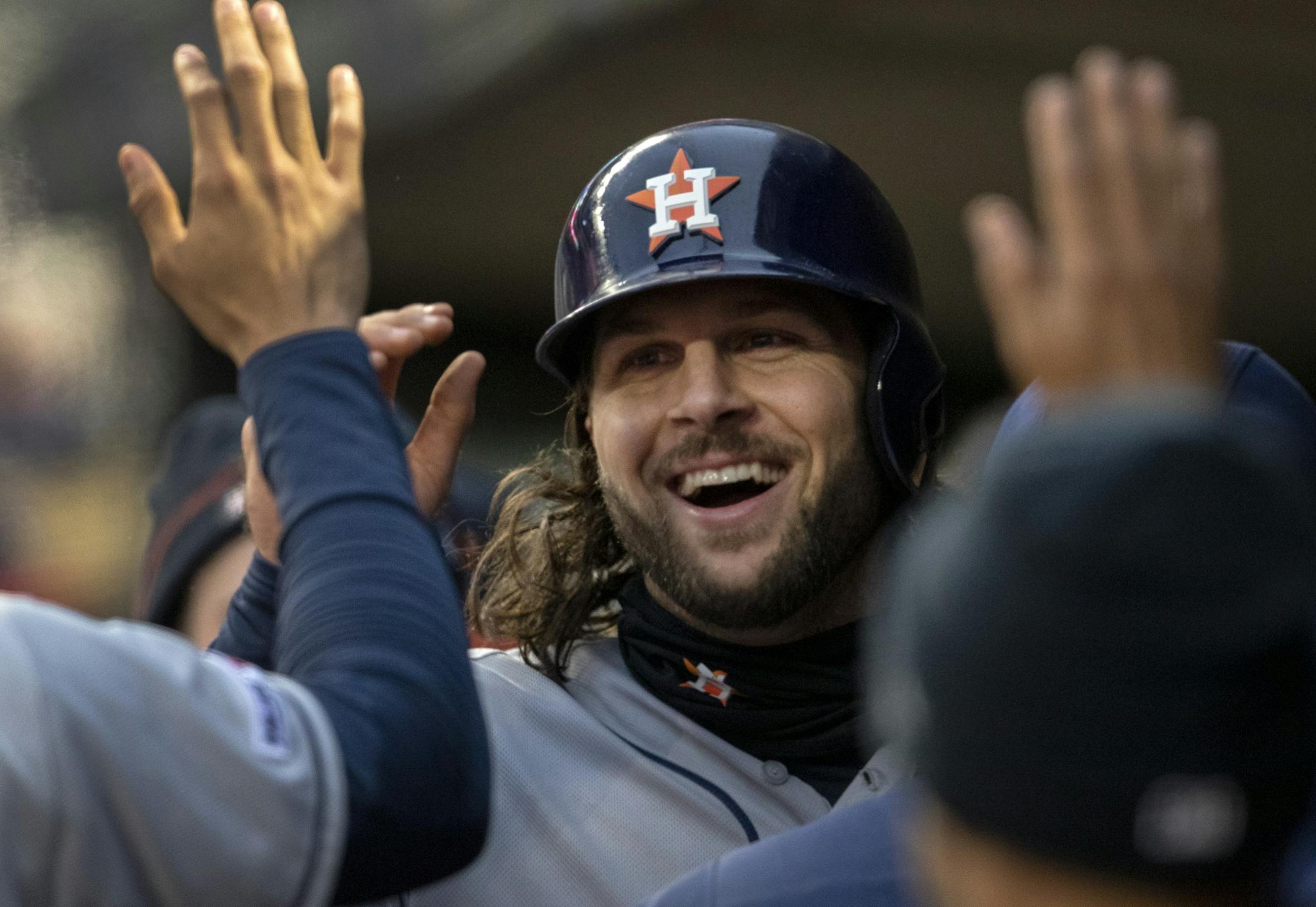 Houston Astros Jake Marisnick celebrated with teammates in the dugout after scoring in the third inning.