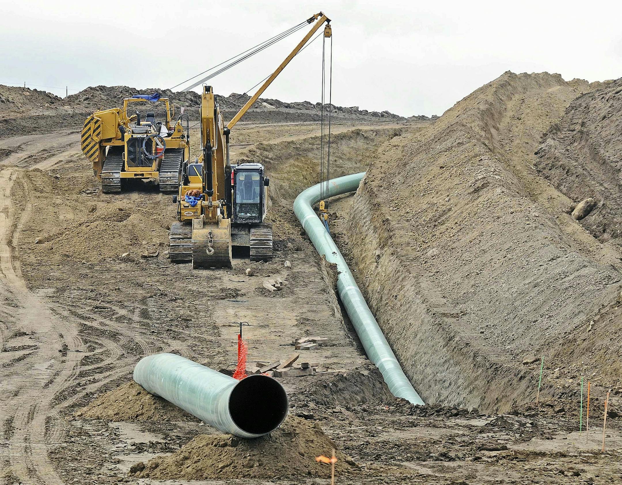 FILE - In this Oct. 5, 2016, file photo, heavy equipment is seen at a site where sections of the Dakota Access pipeline were being buried near the town of St. Anthony in Morton County, N.D. The 1,200-mile line carrying North Dakota oil through South Dakota and Iowa to a distribution point in Illinois began commercial service Thursday, June 1, 2017. (Tom Stromme/The Bismarck Tribune via AP, File)
