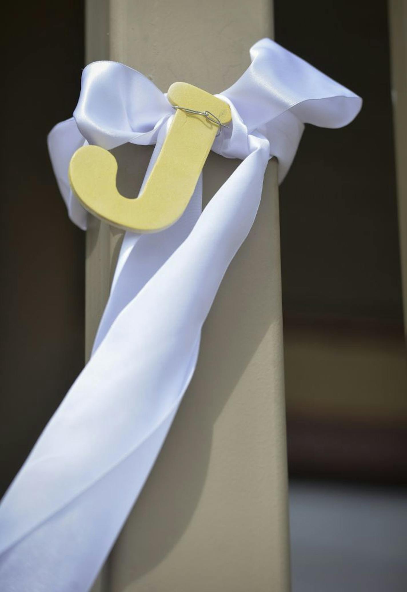 A white ribbon with a large J hangs on a post along Minnesota Street as residents there await confirmation that remains found belong to 1989 abduction victim Jacob Wetterling, Saturday, Sept. 3, 2016, in St. Joseph, Minn. The Stearns County Sheriff's Office says in a statement that Jacob's remains were identified on Saturday. Jacob was 11 when he was kidnapped from a rural road on Oct. 22, 1989, near his home in St. Joseph, about 80 miles northwest of Minneapolis.