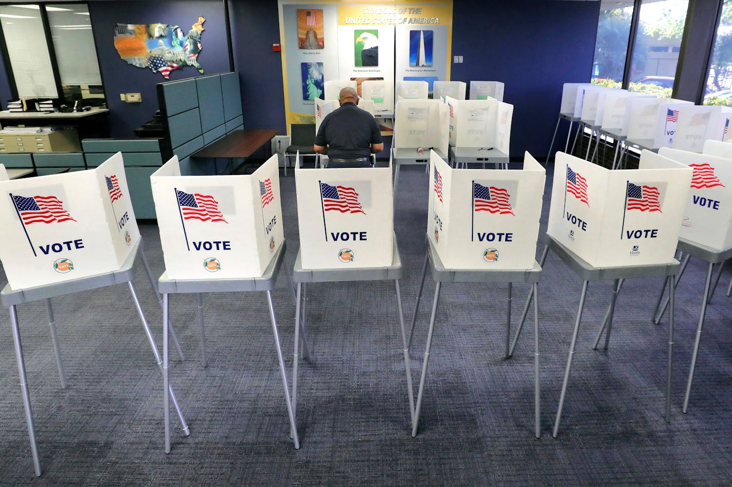 FILE - In this March 17, 2020, file photo, a voter casts his ballot during Florida's primary election