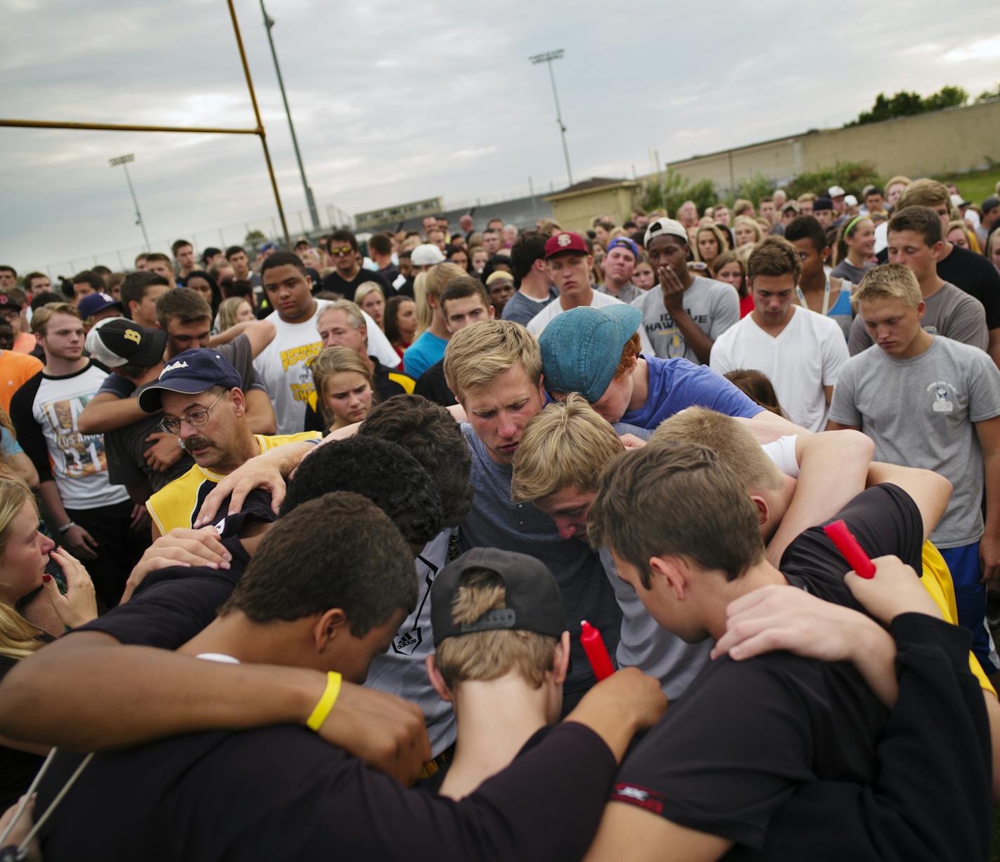 On a sport field at Burnsville H.S. on July 7, 2014, baseball players gathered around Ty's brother, Drew Alyea as they grieved for Ty's passing in a SUV rollover accident. Ty Alyea was a star baseball player. ] Richard Tsong-Taatarii/rtsong-taatarii@startribune.com