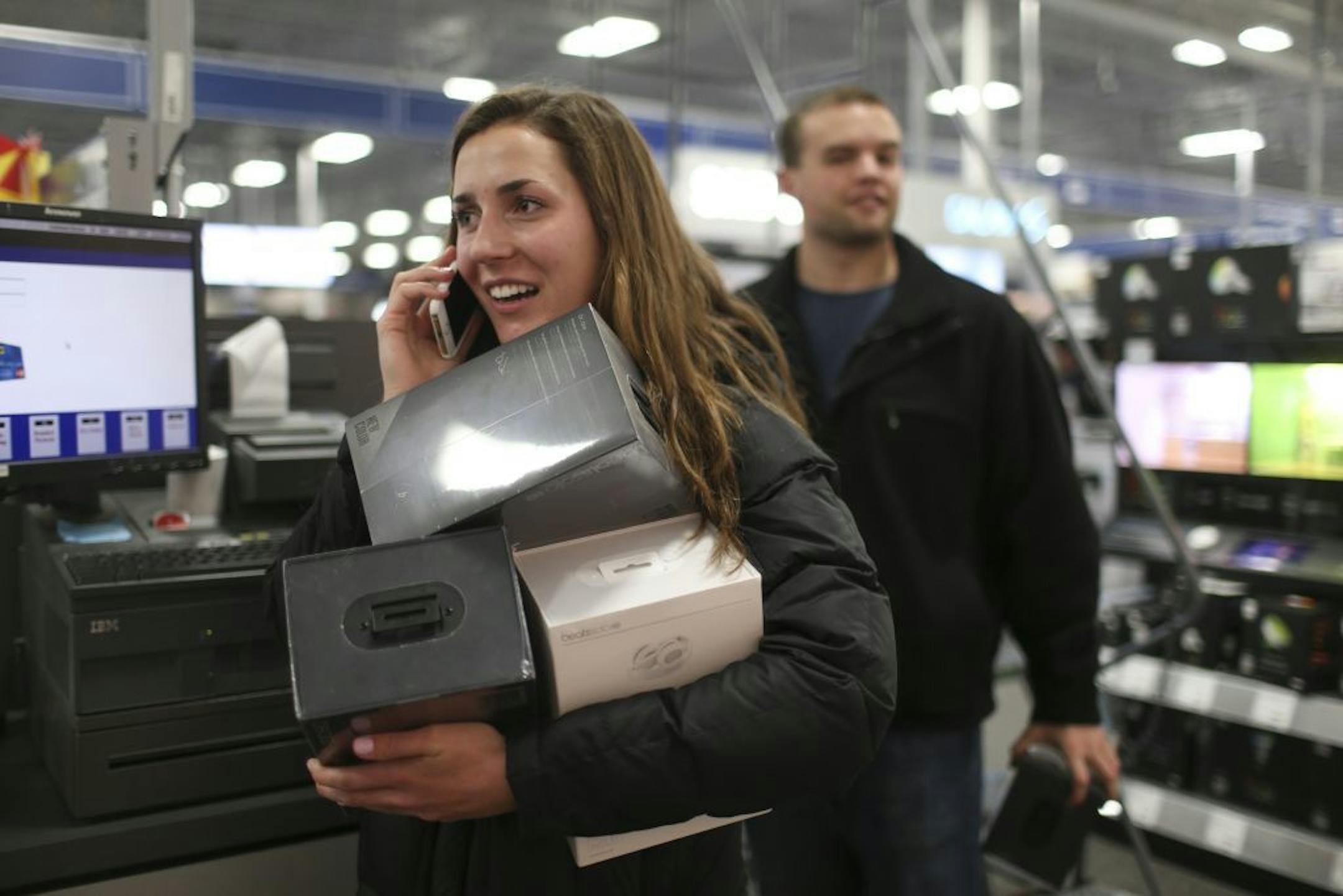 While waiting in line for an iPad, Molly Adam of Vandals Heights was on the phone imploring someone to come and join her at the Best Buy store in Roseville Thursday evening. She had her arms full with Beats headphones.