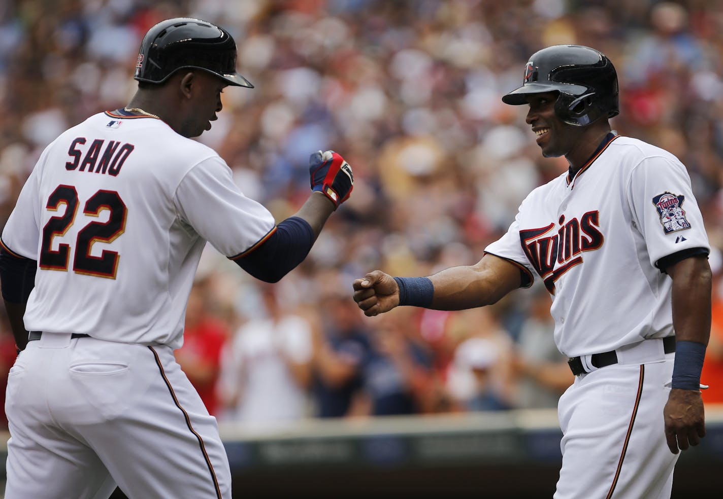 Miguel Sano and Torii Hunter celebrate Sano's second career home run.