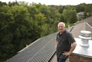 Ray Pruban near the solar array on the roof of his St. Paul home Tuesday afternoon. The solar panels are on the back side of the house and can't be se