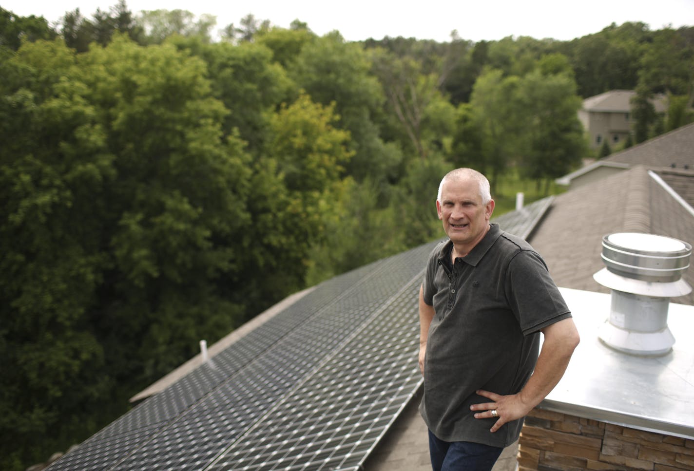 Ray Pruban near the solar array on the roof of his St. Paul home Tuesday afternoon. The solar panels are on the back side of the house and can't be seen from the street, or from the back yard, for that matter, because of the slope of the roof and the yard.