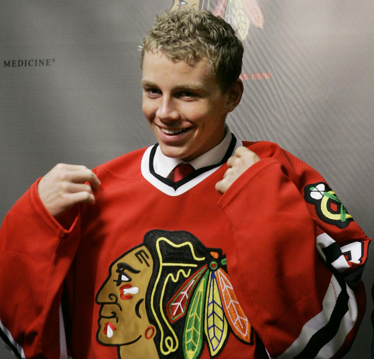 FILE -In this June 25, 2007 file photo, Patrick Kane wears his Chicago Blackhawks No. 88 jersey as he is introduced by head coach Denis Savard at a news conference in Chicago. Kane, the NHL's best rookie in 2008, was charged with robbery and other counts following an altercation with a cab driver in his hometown of Buffalo, N.Y. Buffalo police said the 20-year-old Kane and a 21-year-old cousin, James Kane, had apparently caught a cab from the city's downtown nightclub district at about 4 a.m. Su